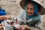 Một phụ nữ đi xe máy "giúp” cụ bà 10.000 đồng rồi giật ví