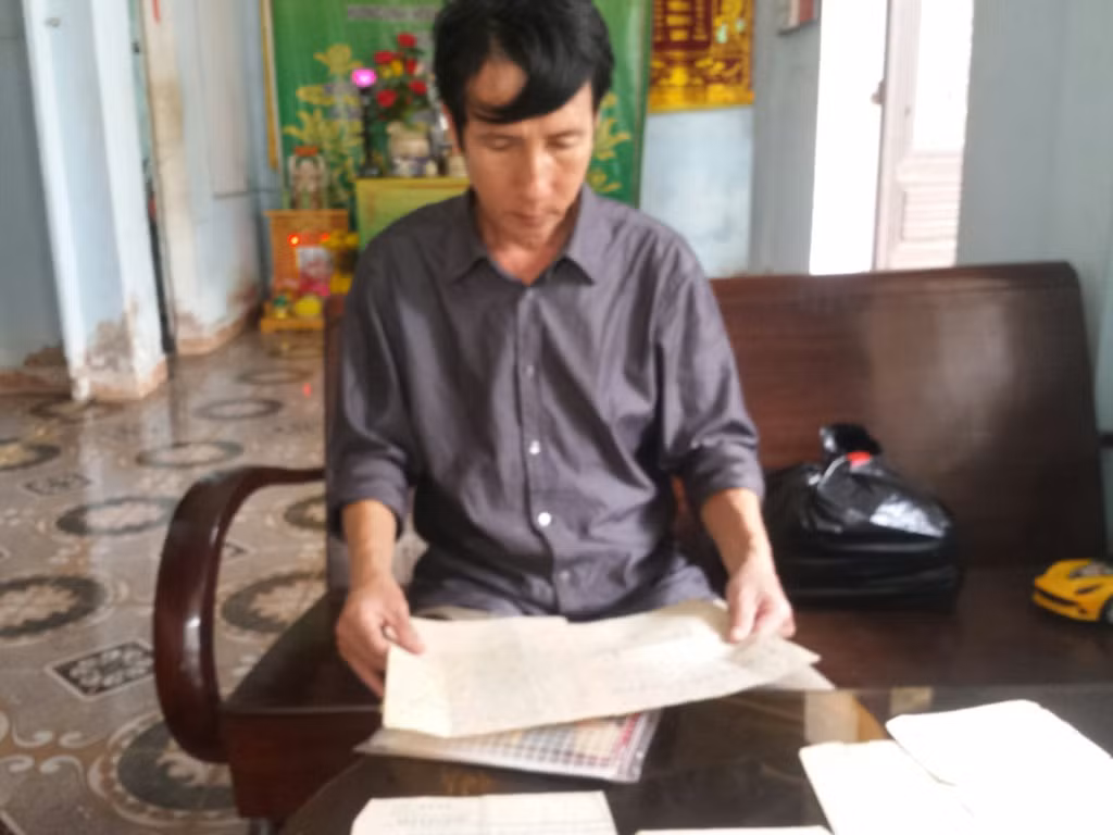 Cựu binh Trần Thiên Phụng cho chúng tôi xem những giấy tờ liên quan. Ảnh: Trị Quảng