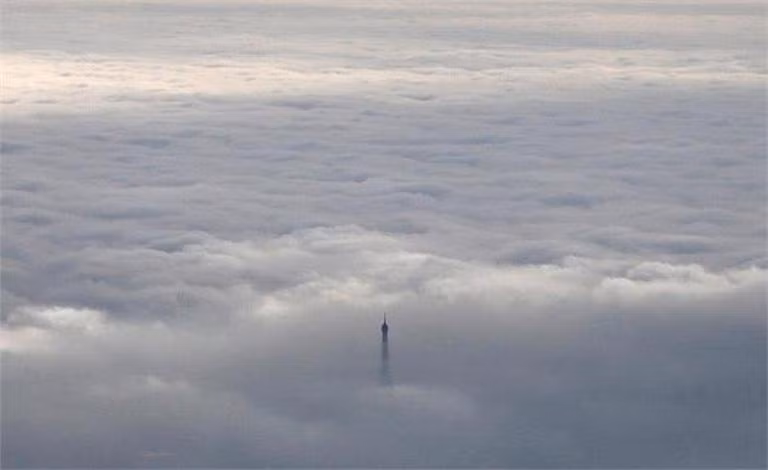 Ngọn tháp Eiffel ngoi lên khỏi làn mây dày đặc ở Paris