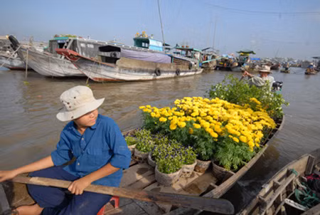 Cậu bé này đang ngồi chờ khách mua hoa. Cậu bé này đang ngồi chờ khách mua hoa.