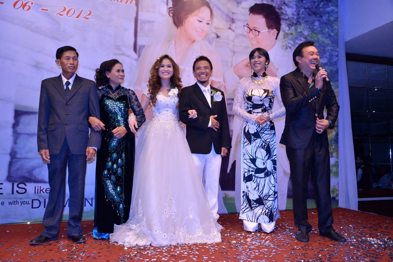 “Cô” Hooài Linh đã đến chúc mừng đôi uyên ương Hồng Tơ - Kim Loan trong trang một bộ áo dài nền nã, thêm nhiều phụ kiện trang sức lấp lánh. Đứng bên cạnh anh là danh hài Chí Tài. (Giaoduc.net.vn)