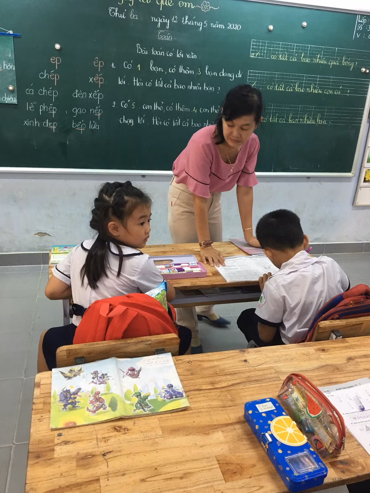 Giờ ra chơi, giáo viên lớp 1 ở tại lớp để kèm thêm học sinh còn chậm (Ảnh Phan Tuyết)