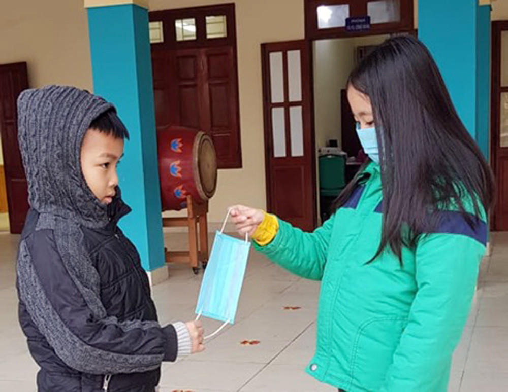 Học sinh Trường tiểu học Dư Hàng (quận Lê Chân) thể hiện hành động đẹp khi thấy bạn không có khẩu trang đã rút ngay khẩu trang dự phòng tặng bạn (Ảnh: CTV)