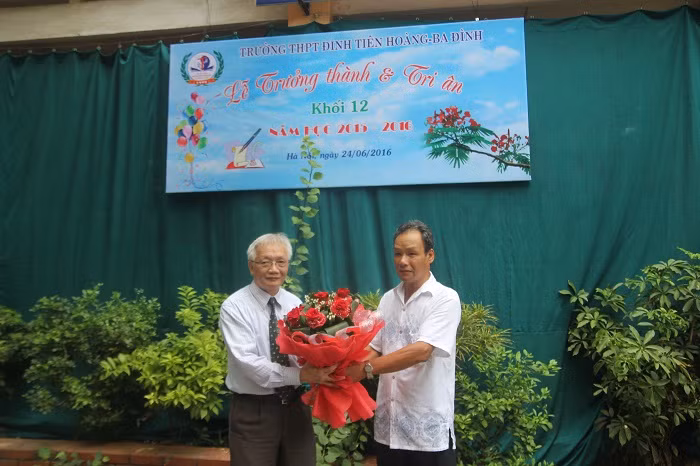 Đại diện phụ huynh học sinh tặng hoa cho lãnh đạo nhà trường.