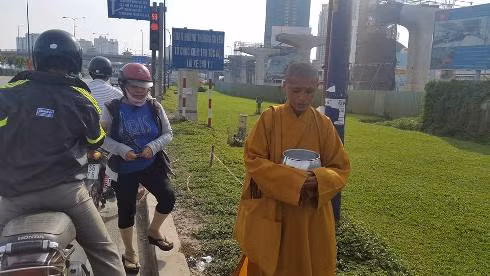Một vị sư giả đang cầm bình bát xin tiền của khách thập phương tại vùng ven TP.HCM (ảnh: P.L)