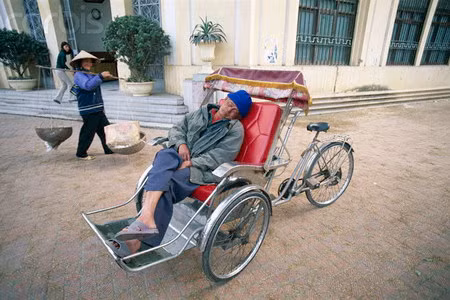 Giấc ngủ giữa đường của một người lái xích lô.