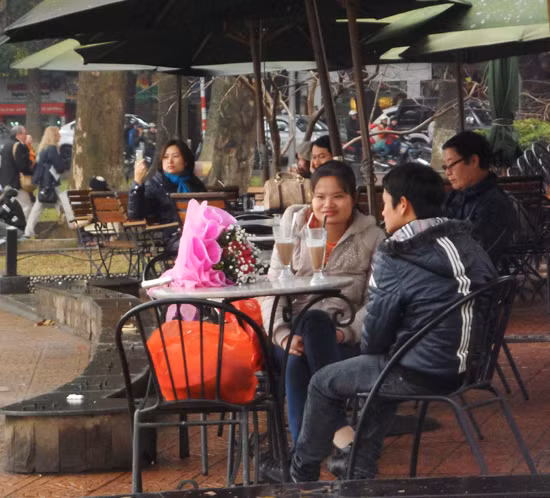 Do trời mưa khá nặng hạt nên một đôi bạn trẻ phải tìm vào quán nhỏ để trú mưa.