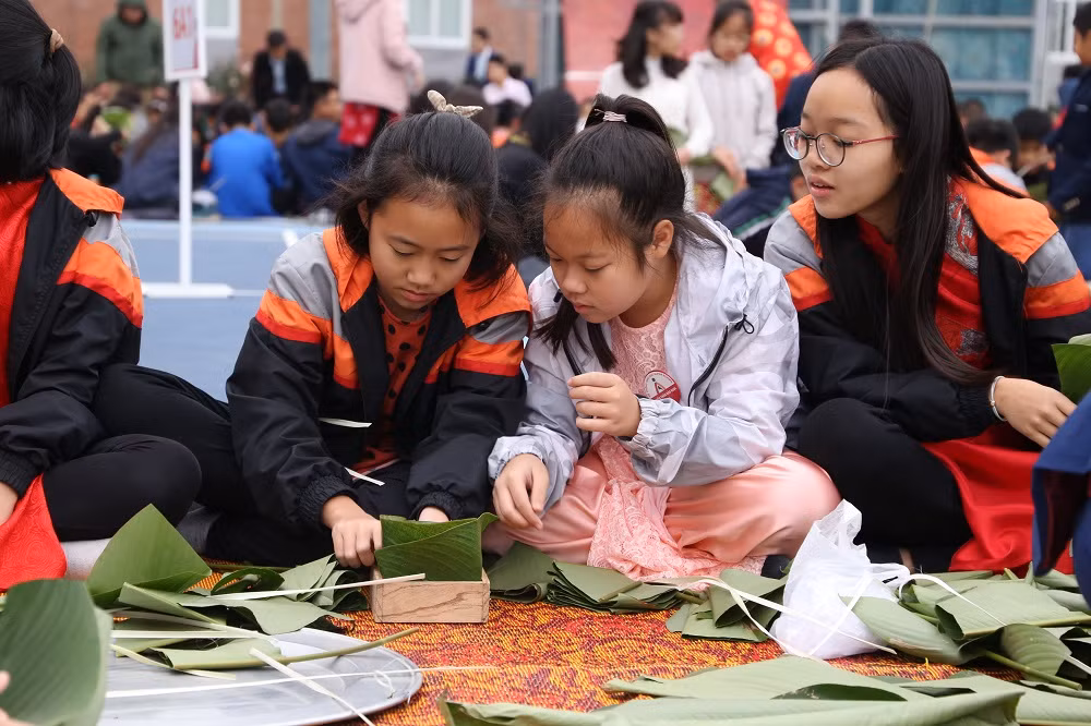 Đối với học sinh được tập gói bánh chưng là một trải nghiệm thú vị.( Ảnh nhà trường cung cấp)