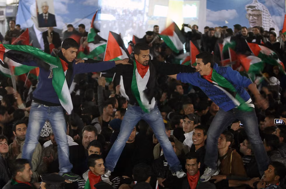 Những thanh niên Palestine kiệu lên vai bạn để vẫy cờ cho thỏa niềm sung sướng
