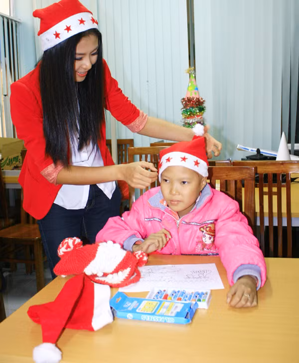 Hoa hậu Ngọc Hân xuống tận nơi đội mũ ông già Noel cho các em nhỏ