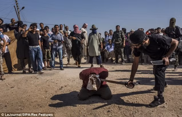 Ảnh tay súng nổi loạn được cho là liên kết với al-Qaeda của tổ chức ISIL chặt đầu đối thủ công bố hồi tháng 12/2013. Ảnh tay súng nổi loạn được cho là liên kết với al-Qaeda của tổ chức ISIL chặt đầu đối thủ công bố hồi tháng 12/2013.