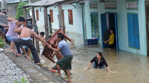 Người dân P.Nhơn Bình (TP.Quy Nhơn) dọn đồ chạy lũ. Ảnh: Tuổi Trẻ./.