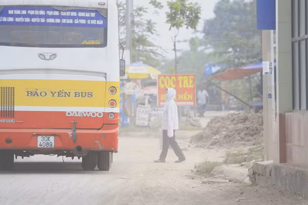 Khách chờ xe bus bịt kín như "Ninja" bên cạnh đống đất
