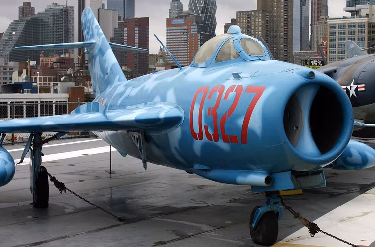 Sở dĩ có sự xuất hiện của chiếc tiêm kích MiG-17 Việt Nam vì nó có mối liên quan với tàu USS Intrepid trong chiến tranh Việt Nam. Con tàu từng được triển khai tham gia chiến dịch không kích miền Bắc Việt Nam. Theo thống kê từ Mỹ (không có sự xác nhận từ Việt Nam) thì máy bay xuất phát từ Intrepid từng bắn hạ được MiG-17 của Việt Nam.