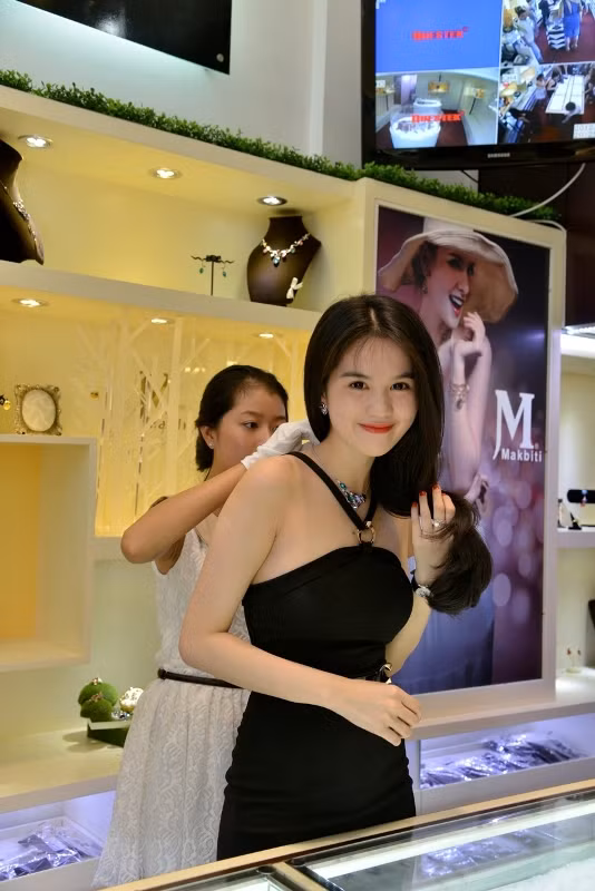 Người đẹp đã nhờ nhân viên cho mình ướm thử một sợi dây chuyền đính ngọc bích. Người đẹp đã nhờ nhân viên cho mình ướm thử một sợi dây chuyền đính ngọc bích.