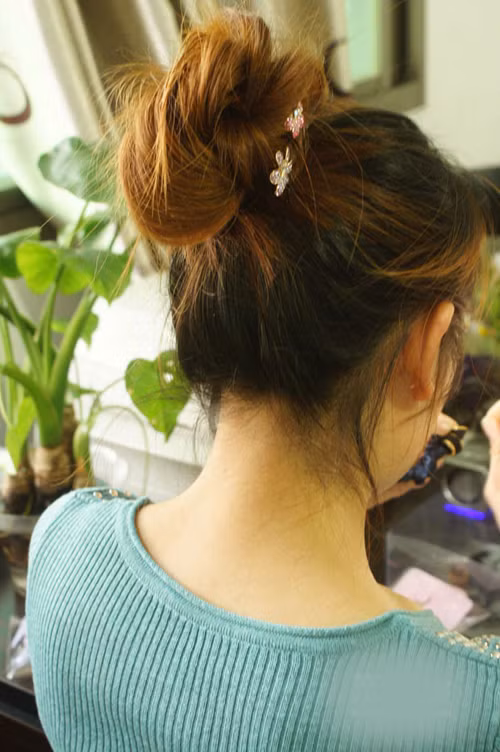 Dùng kẹp tăm giữ chặt cuốn tóc, chú ý trong lúc cuốn tóc không nên cuốn quá chặt sẽ làm mất độ phồng của búi tóc.