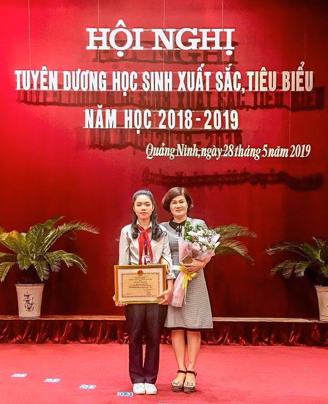 Đào Khánh Huyền và cô Nguyễn Thị Mai Dung, giáo viên bộ môn Ngữ văn của em tại Lễ tuyên dương học sinh xuất sắc, tiêu biểu năm học 2018-2019 do Sở Giáo dục và Đào tạo Quảng Ninh tổ chức. (Ảnh: Đỗ Quang) Đào Khánh Huyền và cô Nguyễn Thị Mai Dung, giáo viên bộ môn Ngữ văn của em tại Lễ tuyên dương học sinh xuất sắc, tiêu biểu năm học 2018-2019 do Sở Giáo dục và Đào tạo Quảng Ninh tổ chức. (Ảnh: Đỗ Quang)