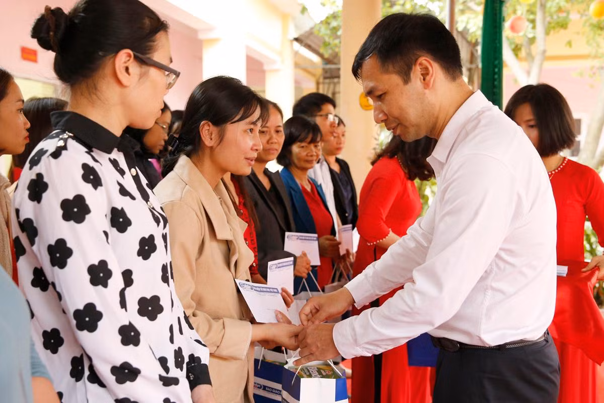 Ông Nguyễn Tiến Lâm - Phó Bí thư thị Ủy, Chủ tịch Ủy ban nhân dân thị xã Phú Thọ cùng lãnh đạo Tạp chí điện tử Giáo dục Việt Nam tặng quà Tết cho học sinh có hoàn cảnh khó khăn. Ảnh: Tùng Dương.