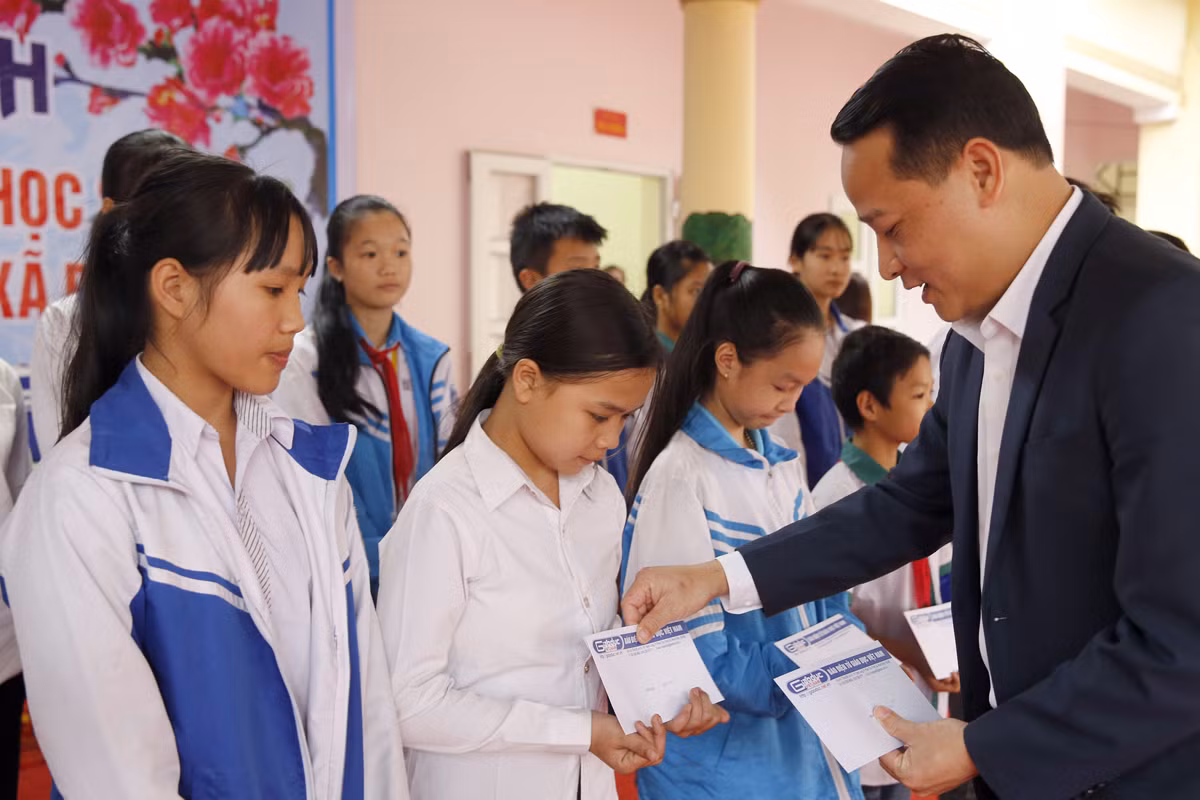 ông Nguyễn Công Huân - Phó chủ tịch Ủy ban nhân dân thị xã Phú Thọ, trao quà Tết cho học sinh có hoàn cảnh khó khăn. Ảnh: Tùng Dương.