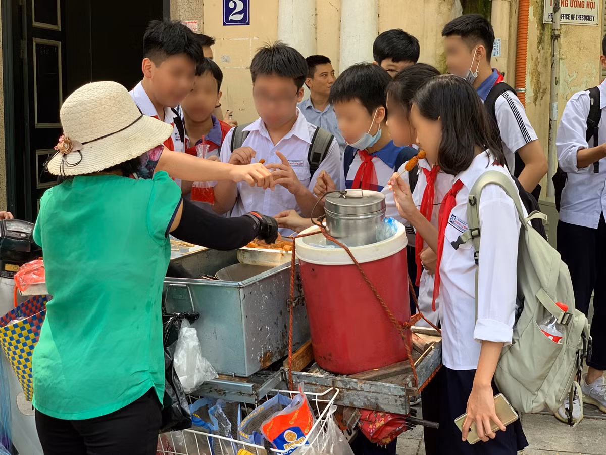 Hàng rong cổng trường tại góc phố Ngô Thì Nhậm - Hàm Long, Hà Nội. Ảnh: Tùng Dương.