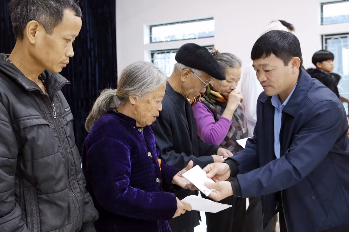 Ông Hà Xuân Thủy - Phó chủ tịch Ủy ban nhân dân thị trấn Thanh Sơn đang trao quà cho các hộ có hoàn cảnh khó khăn. Ảnh: Tùng Dương.