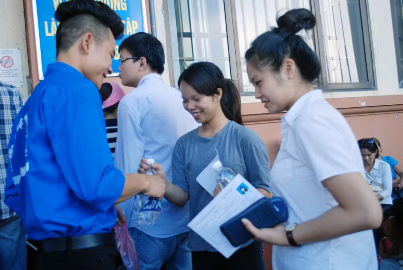 Trước khi vào thi các thí sinh được tình nguyện viên hướng dẫn mang nước vào để chống chọi với nắng nóng.