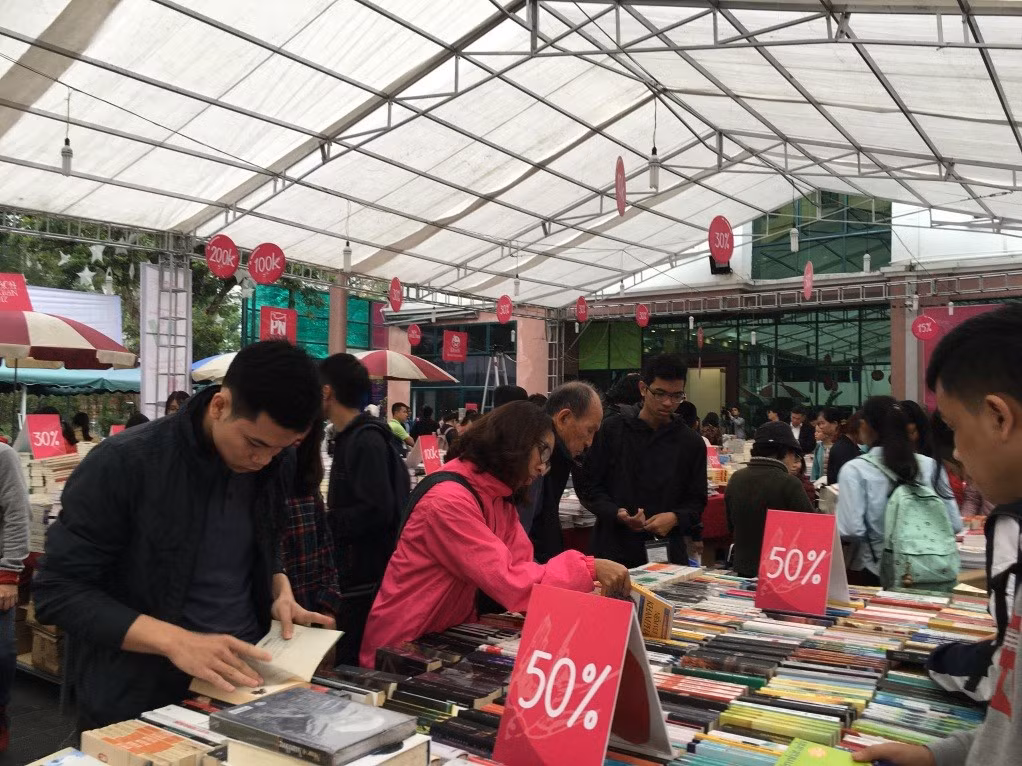 Gian hàng sách giảm giá 50% tấp nập người xem sách, lựa sách.