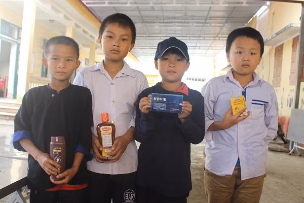 Các em học sinh vui vẻ khi được nhận quà tặng như viên uống Kovir, dầu gừng Thái Dương