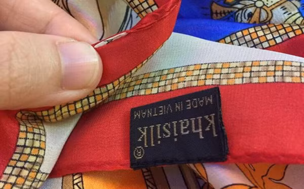 Việc cắt nhãn “Made in China” để khâu nhãn “khaisilk made in Vietnam” được chính ông chủ hãng Khaisilk thừa nhận. (Ảnh trên Tienphong.vn)