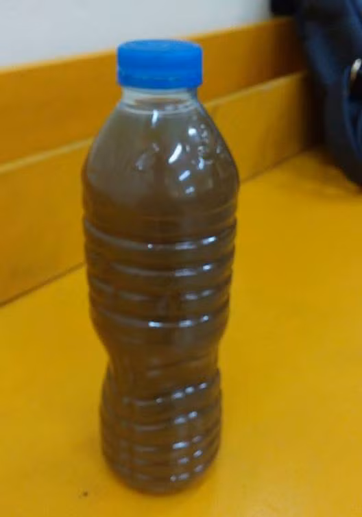 Một chai thuốc có màu nâu sậm, không nhãn mác, không rõ nguồn gốc có giá 500 nghìn đồng (ảnh: TRINH PHÚC).