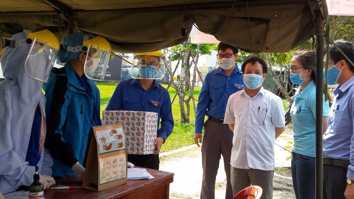 Phó Giáo sư Nguyễn Ngọc Vũ (áo trắng) đến thăm hỏi, động viên lực lượng sinh viên tình nguyện đang tham gia chống dịch tại cửa ngõ ra vào thành phố. Ảnh: HT