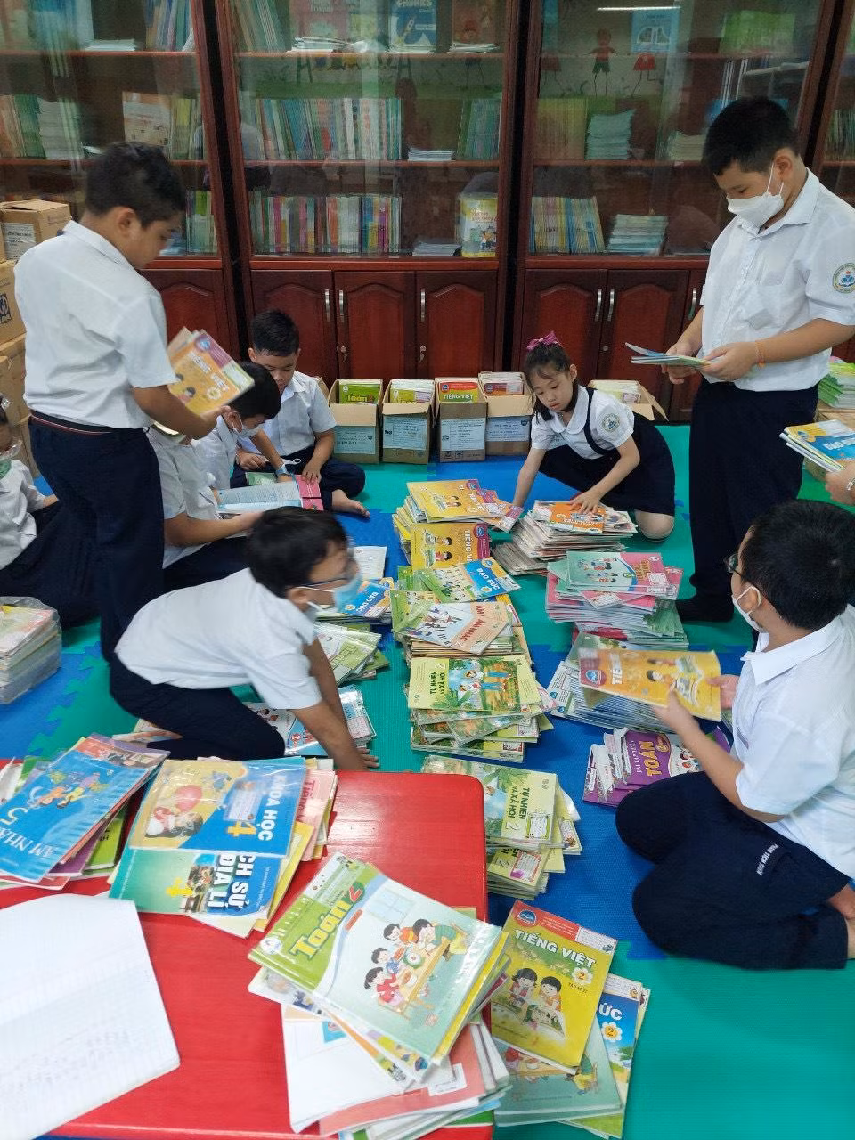 Các em học sinh sửa sang, phân loại sách theo bộ/lớp Các em học sinh sửa sang, phân loại sách theo bộ/lớp